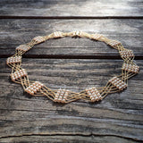 Woven gold chain and pearl necklace