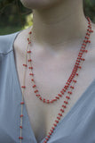 Model wearing coral Rain necklace designed by Estyn Hulbert