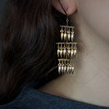 3 Tiered gold bullet earring on model