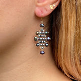 Model wearing large Kilim earrings in blue pearl, silver and 14k gold