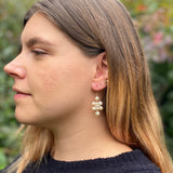 Model wearing small white pearl Kilim earrings