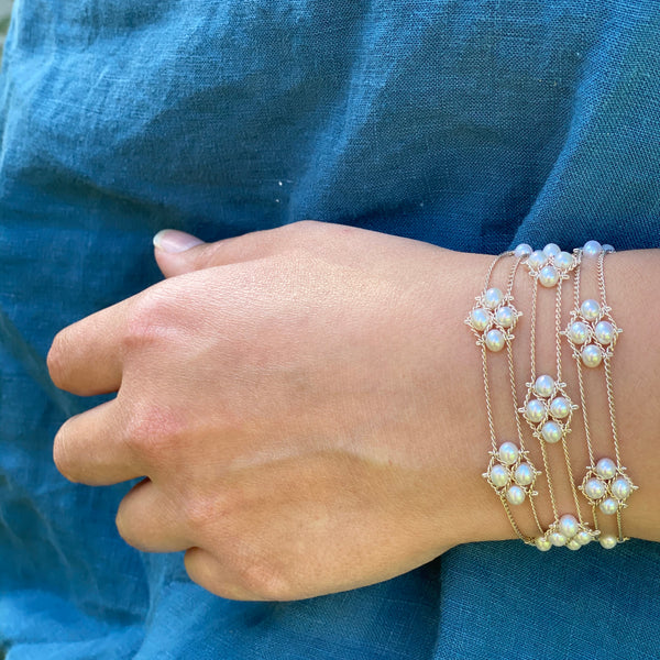 Model wearing pearl and silver bracelet