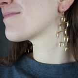 Gold Bullet La Donna earrings on model